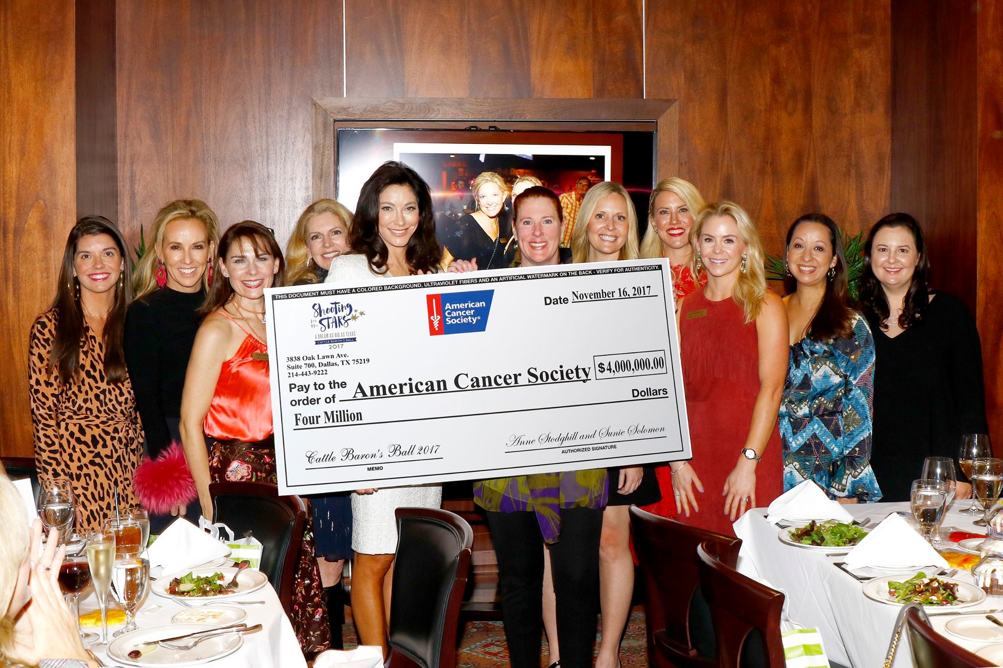 picture of A group of women posing around a charitable donation of four million dollars to the American Cancer Society