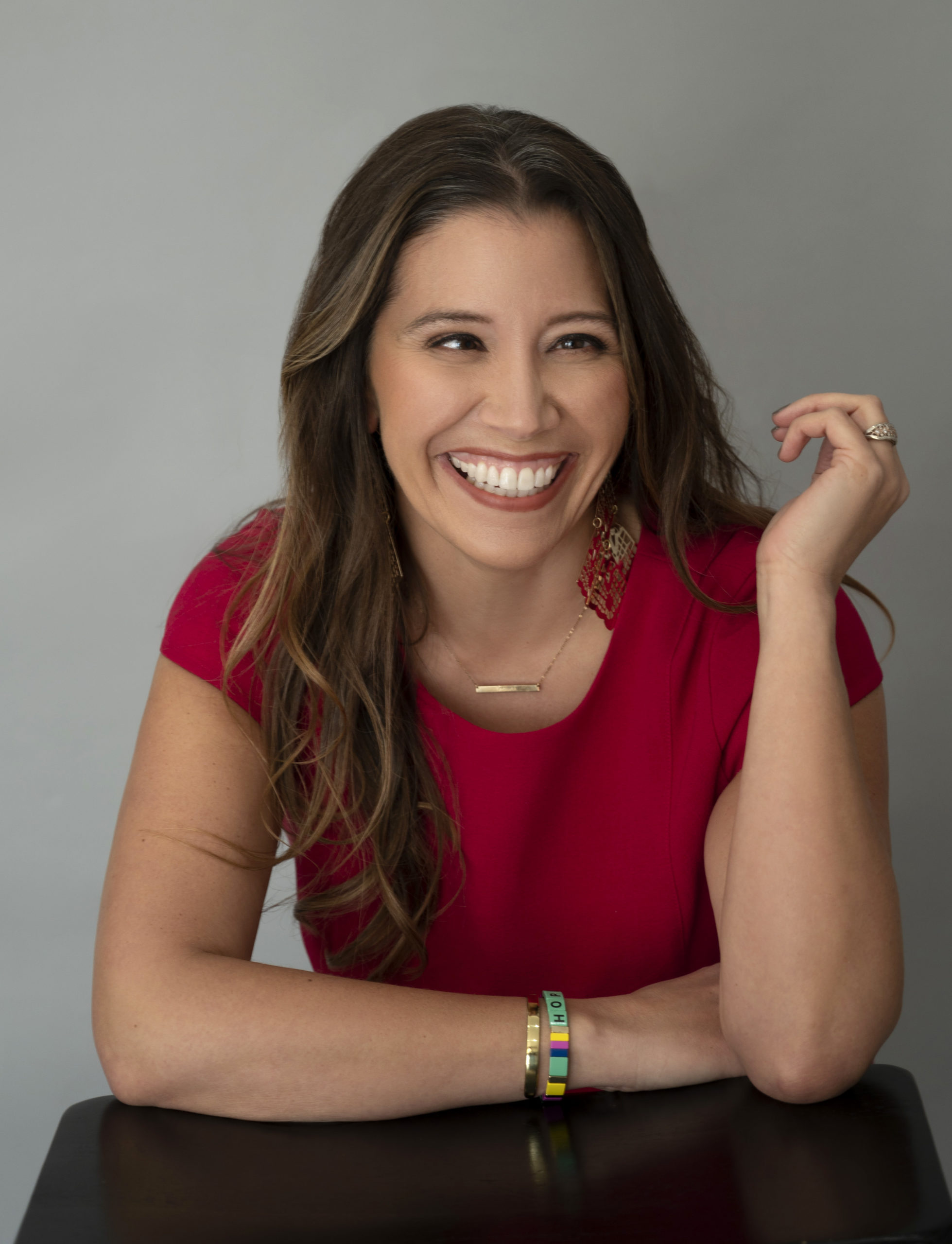 picture of event coordinator Amber Scheer in a red dress, smiling