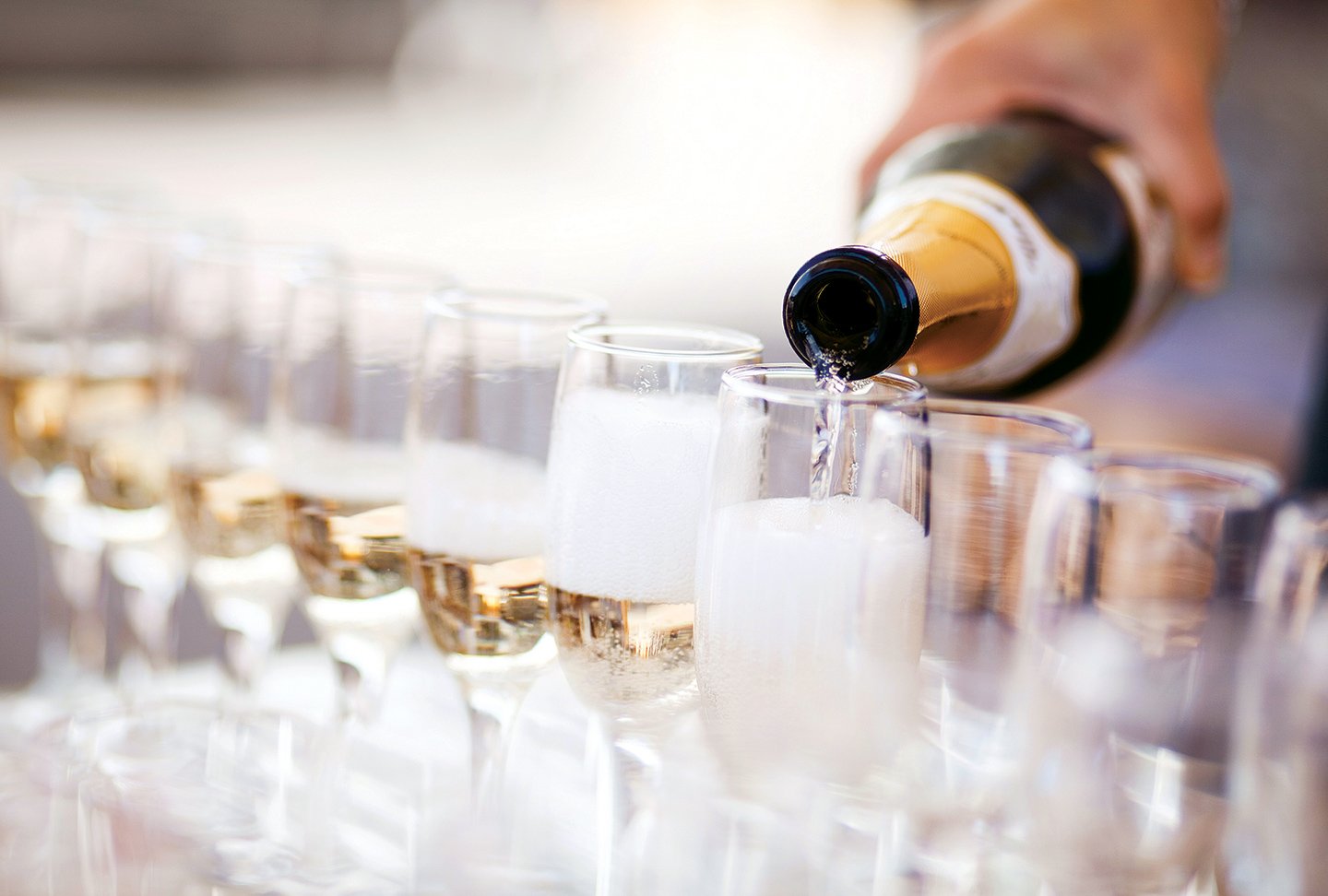 picture of A long row of champagne flutes being filled
