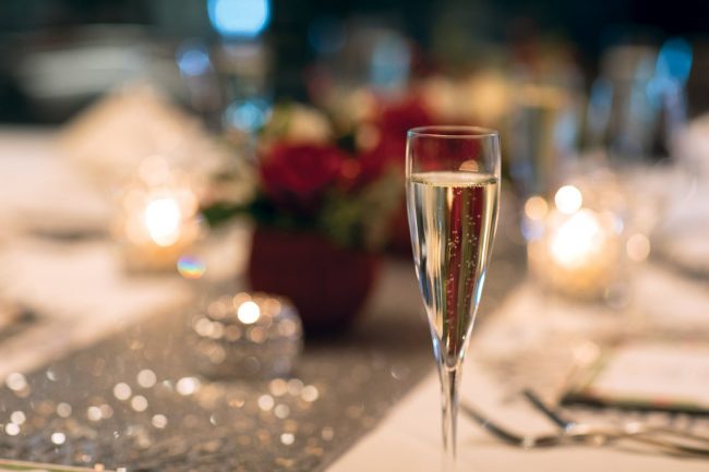 picture of champagne flute in front of private dining holiday table