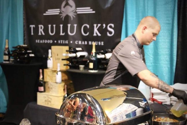 picture of Chef Partner Shane Flynn cooking at an offsite charity event.