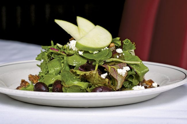 picture of SONOMA GREENS SALAD spicy pecans, goat cheese, apples, kalamata olives, honey vinaigrette