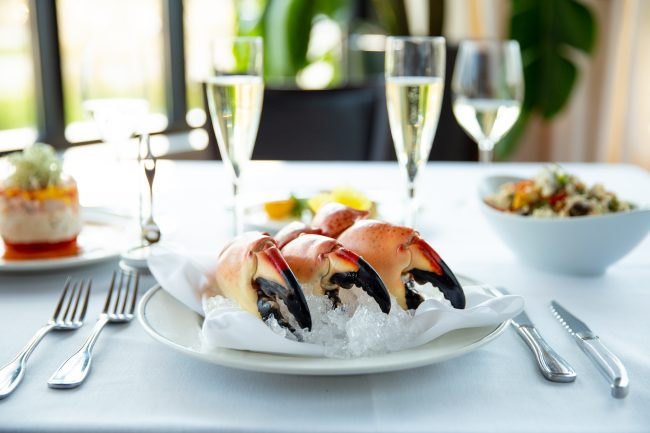 picture of Florida Stone Crab Claws on ice in the Truluck's dining room. Paired with crab Napoleon, crab fried rice and champagne.