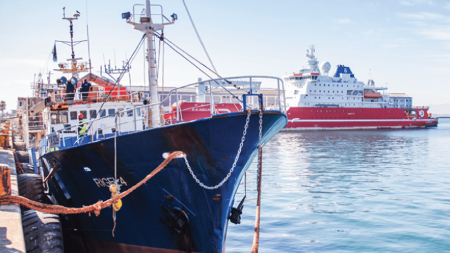 picture of the RIGEL 4 lobster fishing boat at the dock with another large ship in the background