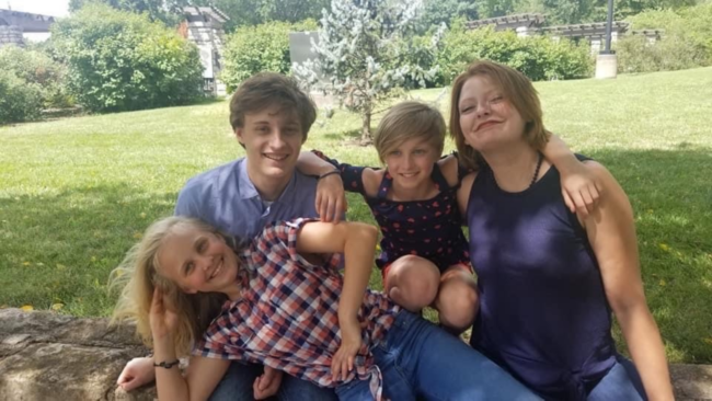 Cary Grider's children at the park posing for a group picture.